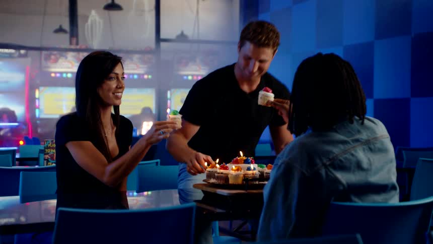Friends celebrating together a celebration with cupcakes with candle