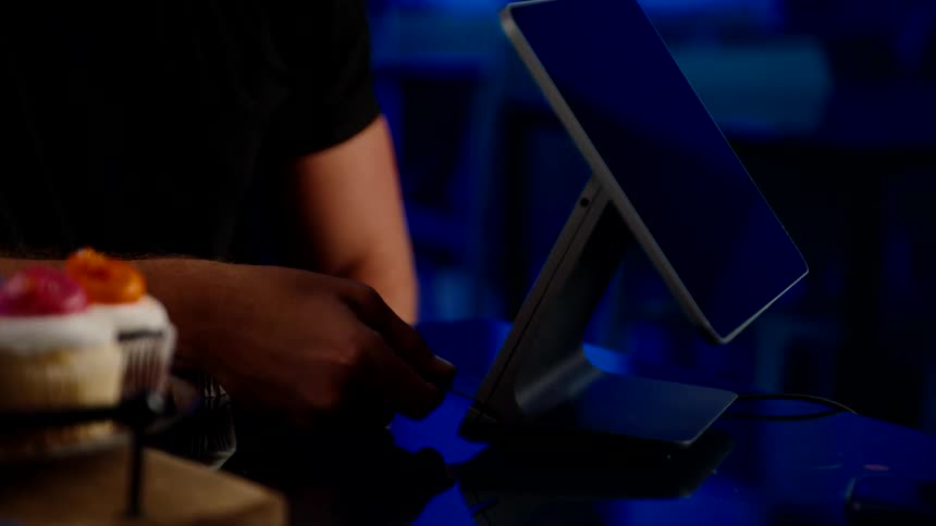 A customer inserts their credit card into the card reader