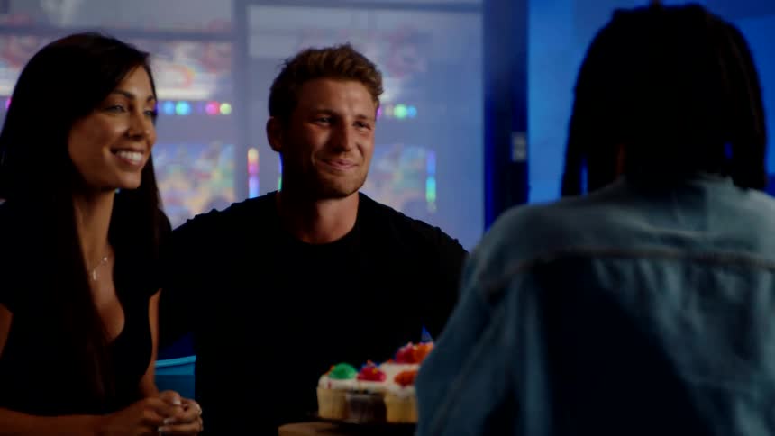 Friends smile and take a selfie with cupcakes at an arcade celebration