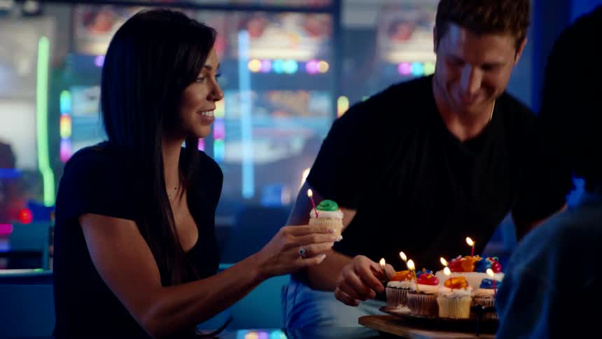 Friends celebrate with cupcakes at an arcade