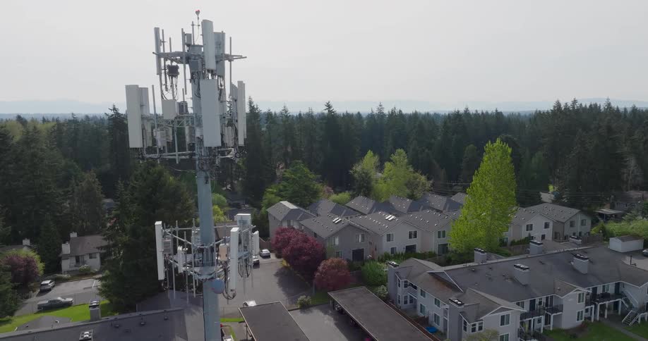 Close approach towards a 5G cell tower working near a nice residential area