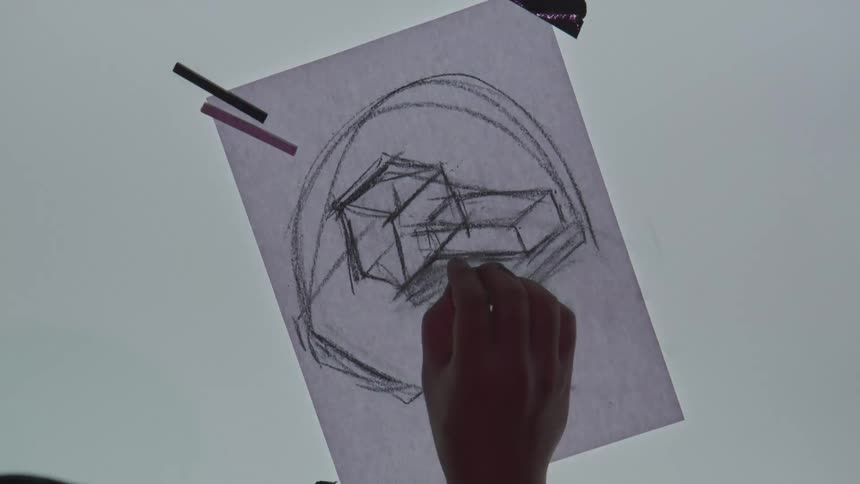 A sketch artist draws on a piece of paper