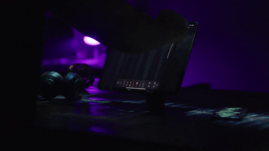 A person moves a pen across a tablet