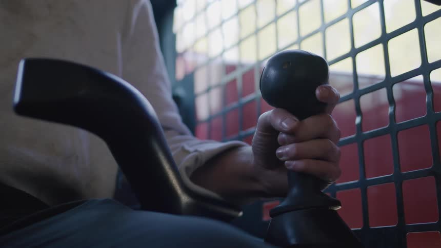 Persons hand controlling a machinery