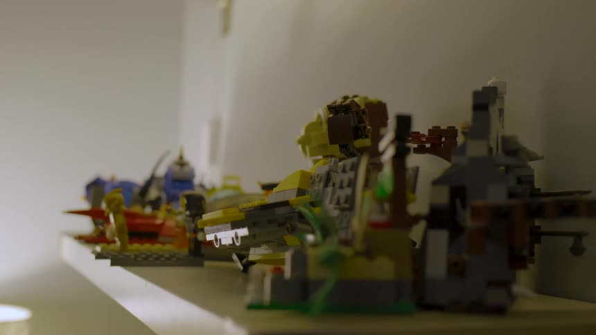 Several lego builds on display on a shelf