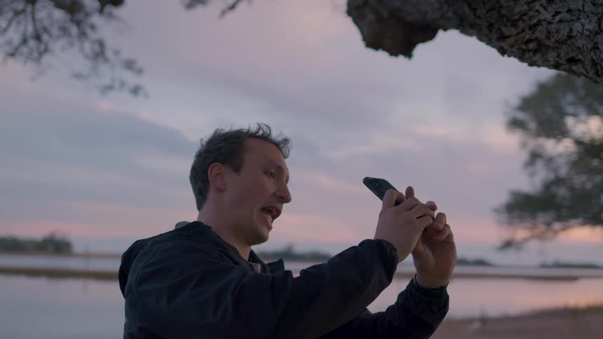 A man talks to someone on his phone while showing them his current view