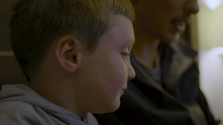 Boy listens while his father reads to him