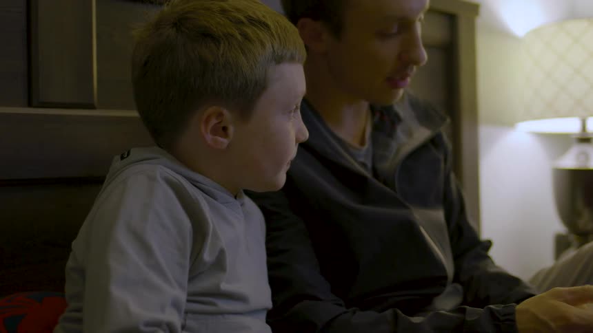 A father reads to his son