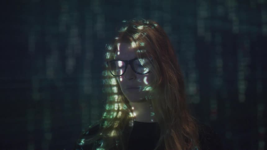 A woman stands in front of a projection