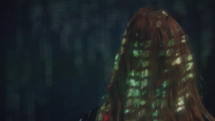 Digital special effects reflect on the back of a womans hair