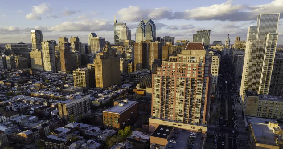 A Philadelphia skyline view with a series of buildings highrises and skyscrapers under the midday sun