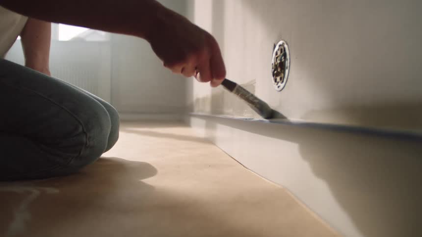 A person paints a wall