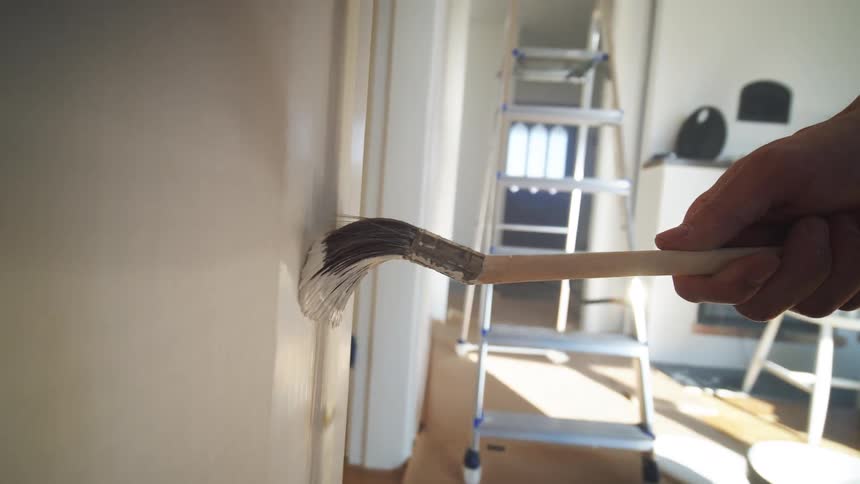 Dragging a paintbrush up and down a wall