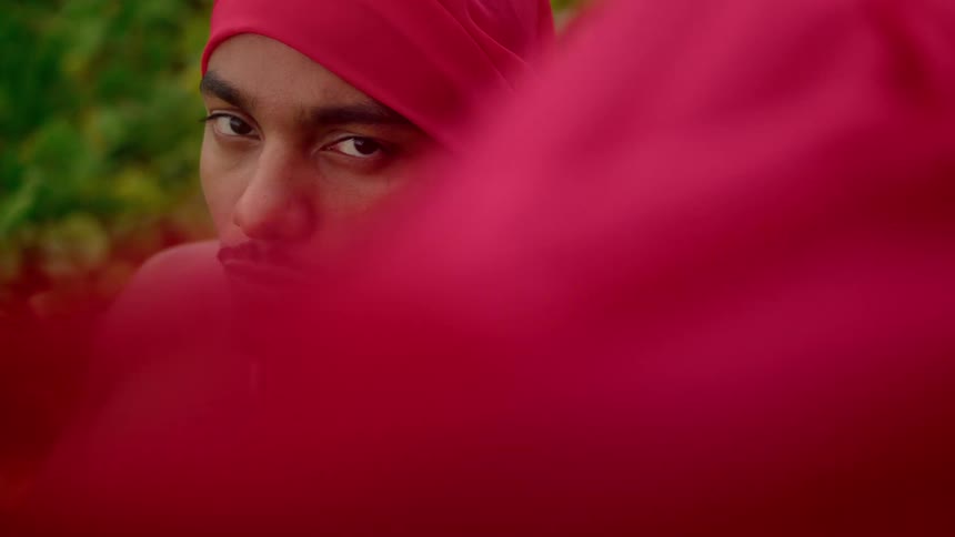 A man with a red cape billowing around him