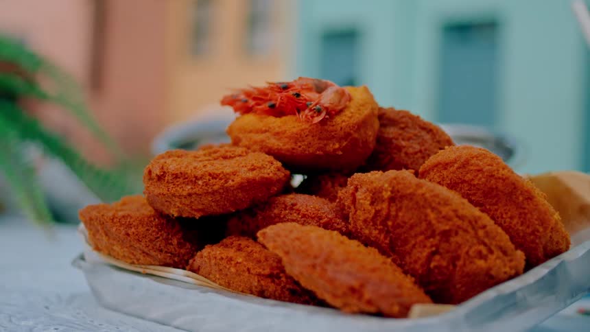Nuggets stacked in a bowl placed on top of a table