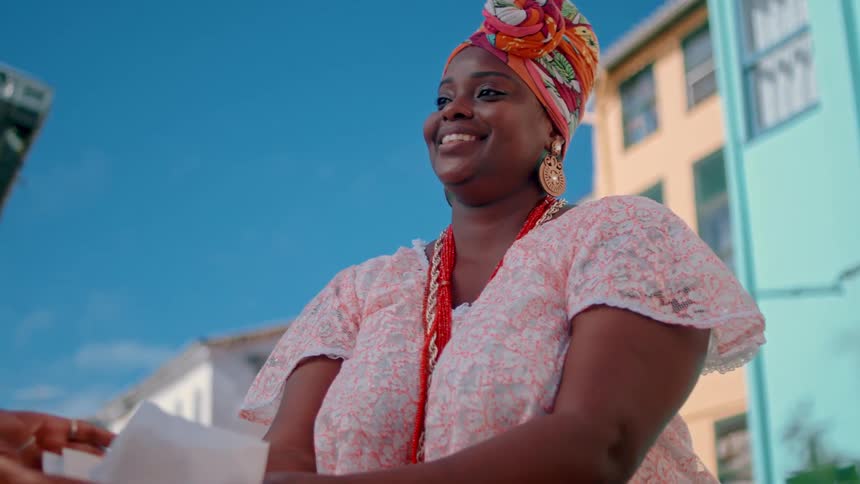 A woman serves food and smiles