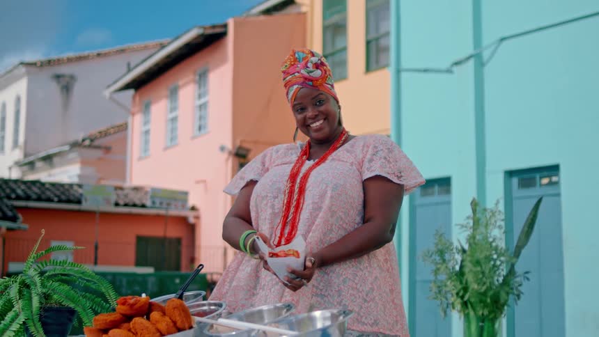 A woman displays the food at her vendor table