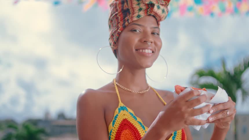 A woman happily holds some food