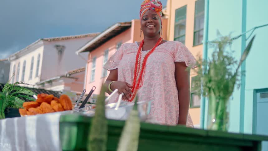Two people in a canoe paddle toward the shore at sundown