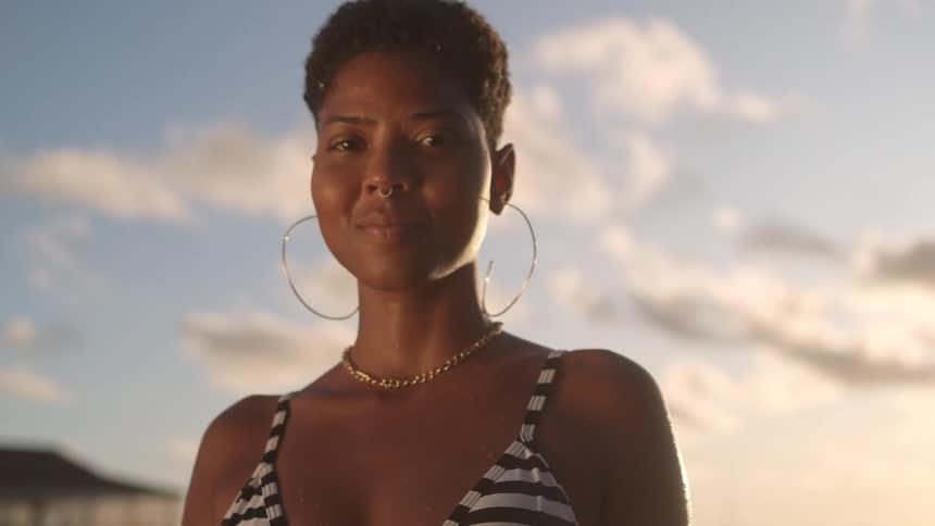 A woman in a bikini is smiling