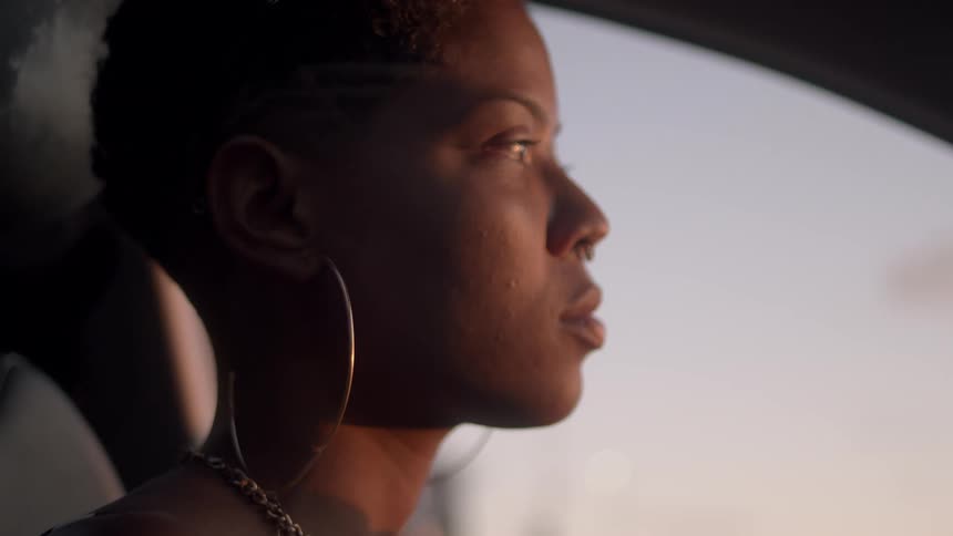 A woman sits in a car