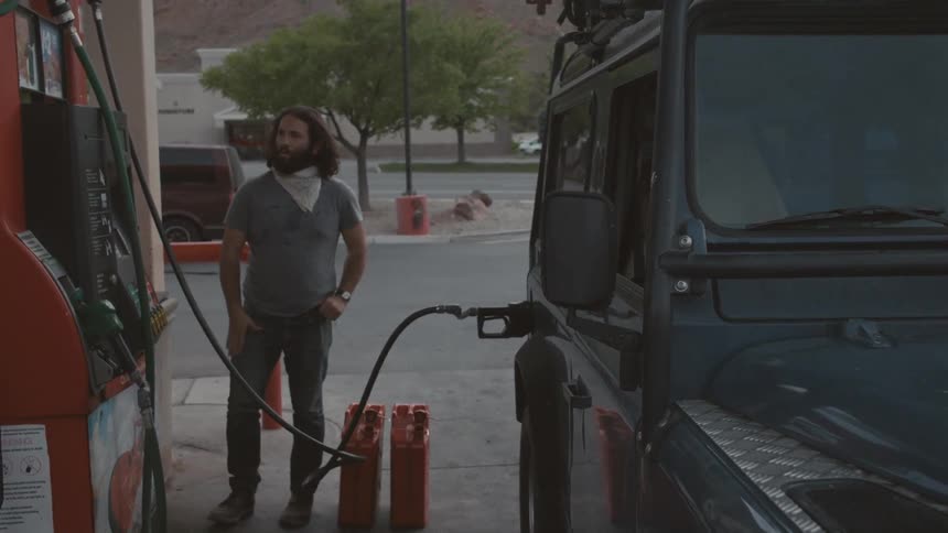 A person filling up a car with gas