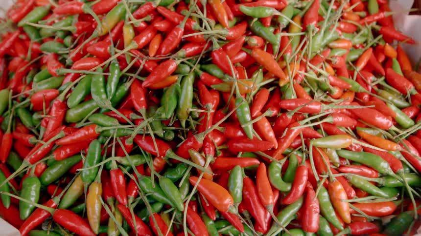 The basket is full of red and green peppers