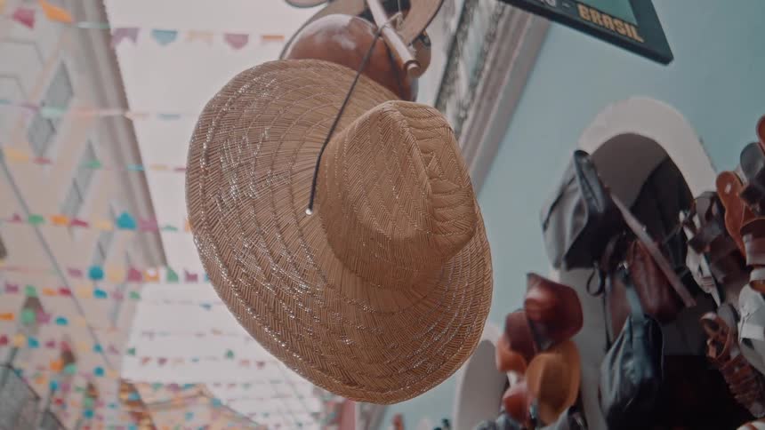 Hats hang in front of the shop outside