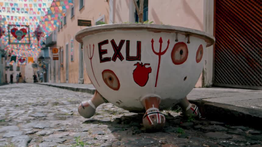A large bowl is covered with graffiti on the road