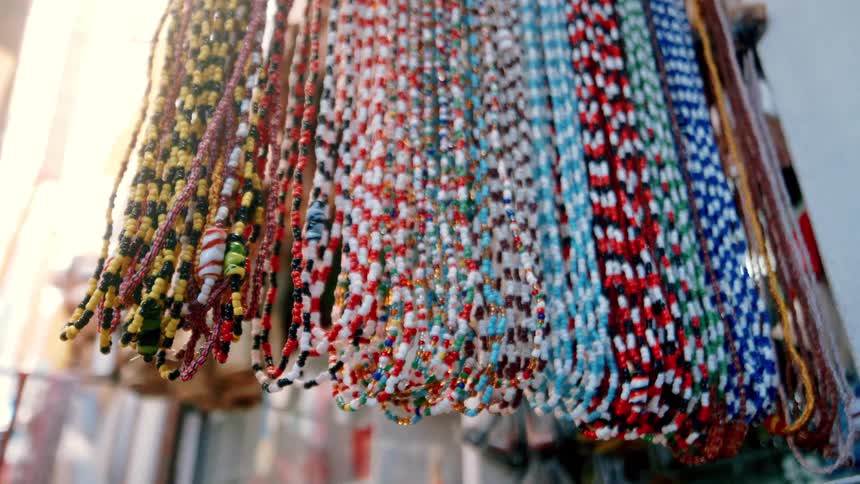 Colorful handmade beads hanged near the wall at daytime