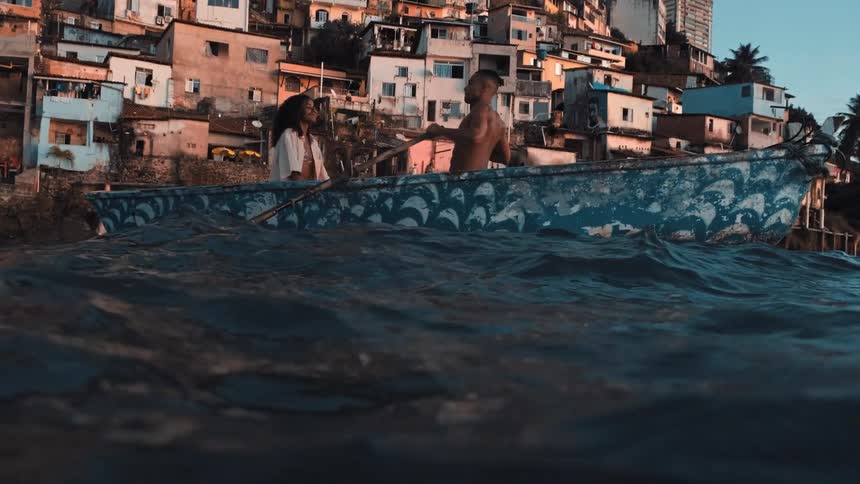 A man and woman sit in a small row boat