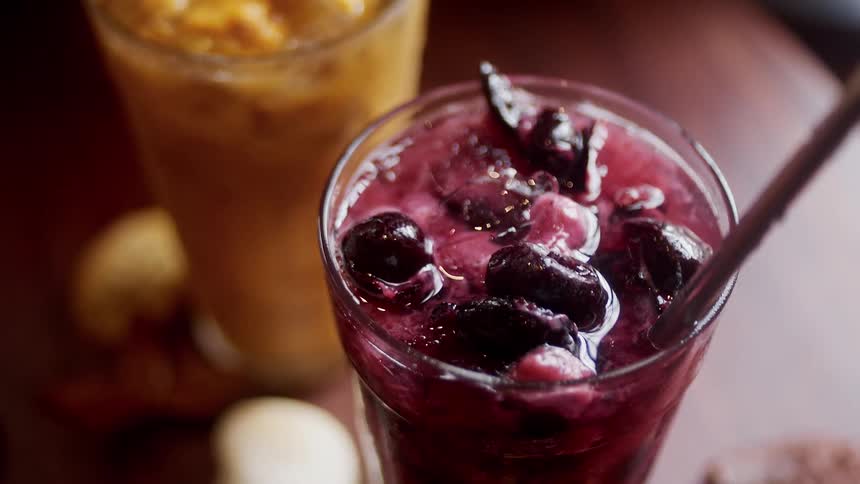 Closeup of two refreshing fruit drinks on a wooden table