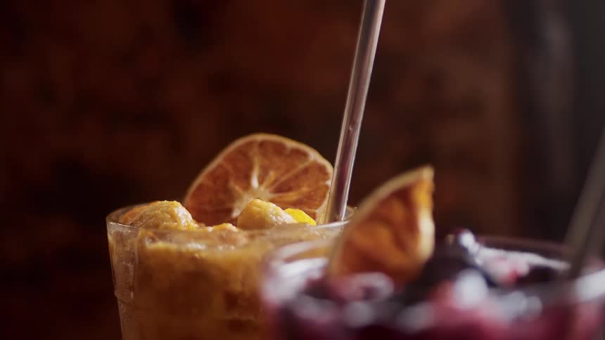 Two glass of drink with straw on them