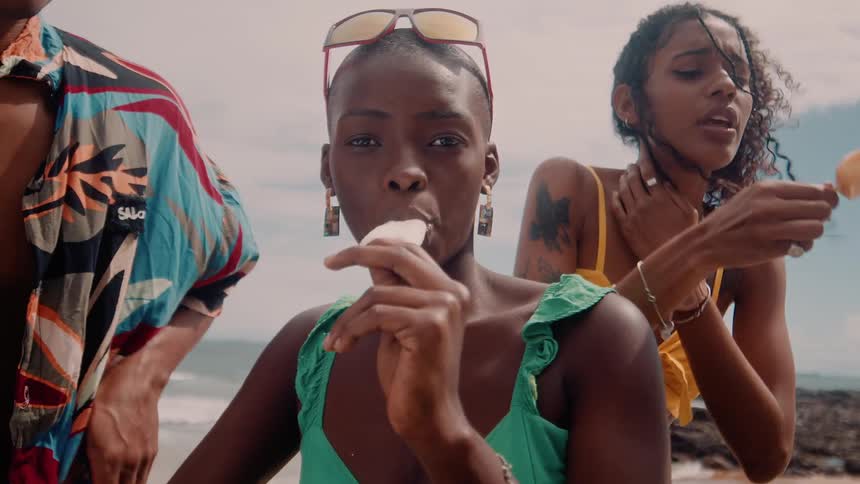 Friends at the beach enjoying ice cream and having fun together