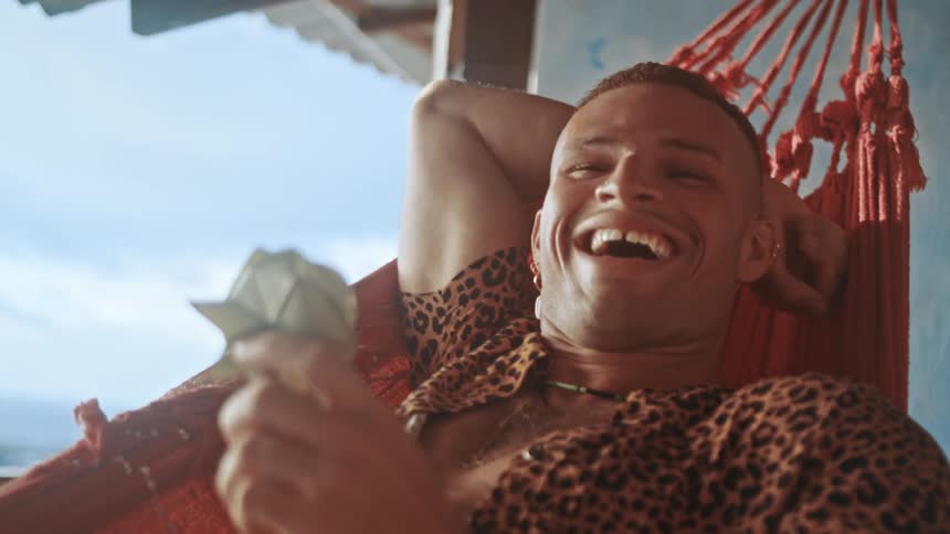 A man relaxes at a resort laughing and enjoying himself while having a good time