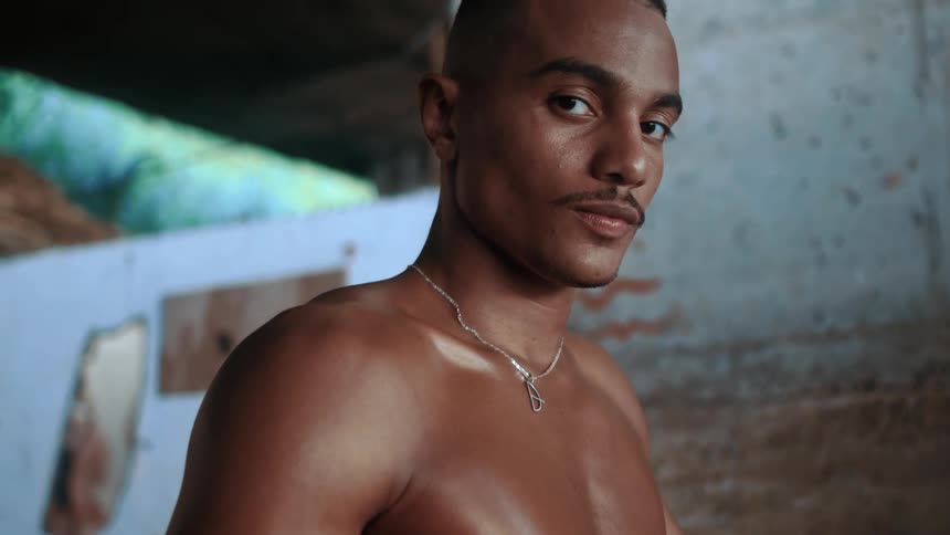 Close up of a young black man using a phone while standing indoors during daytime