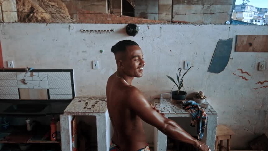 A man is rubbing oil on his arm