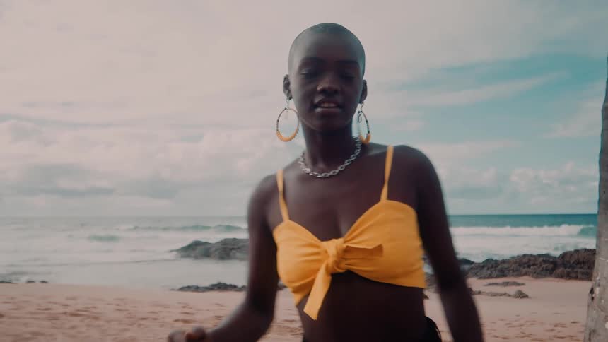Two friends dance and enjoy themselves on a tropical beach