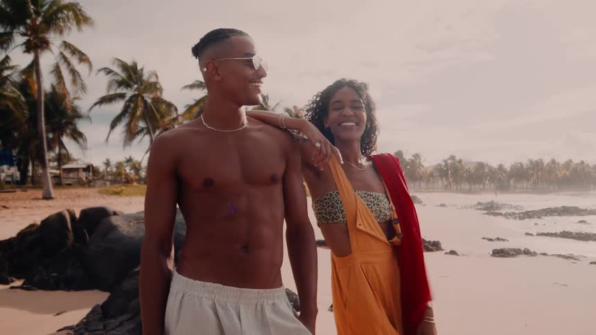 Happy man and woman enjoying summer time on the beach