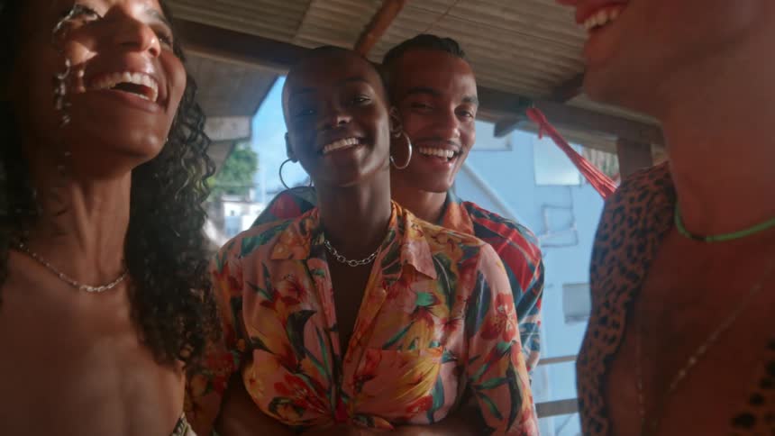 Group of black friends dance and party at a balcony during daytime