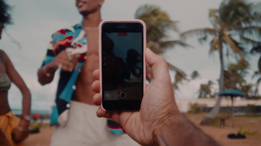 People are being filmed dancing on the beach