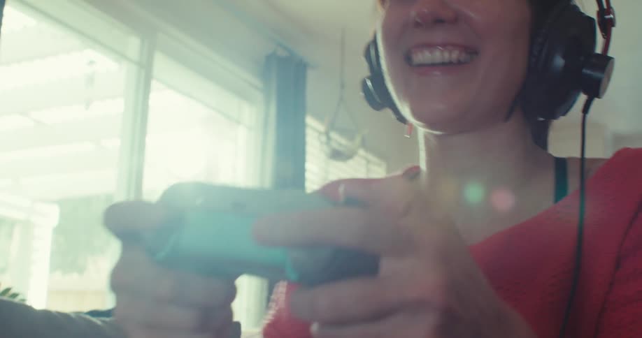 The woman laughs as she plays video games