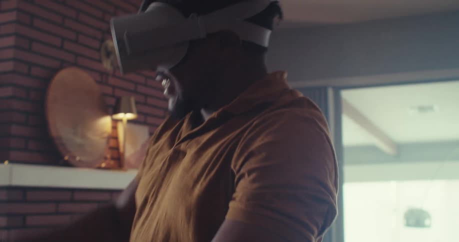 A man at home in his living room playing virtual reality video games