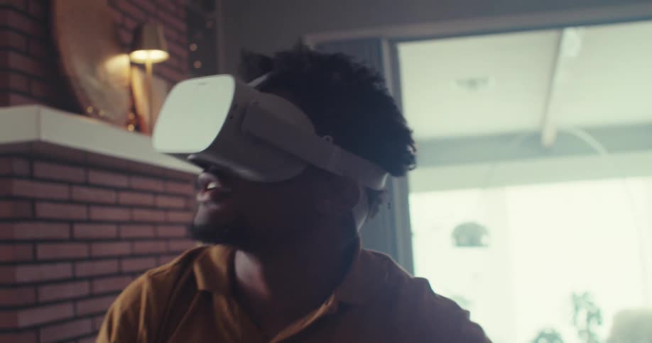 Man in a living room using virtual reality glasses