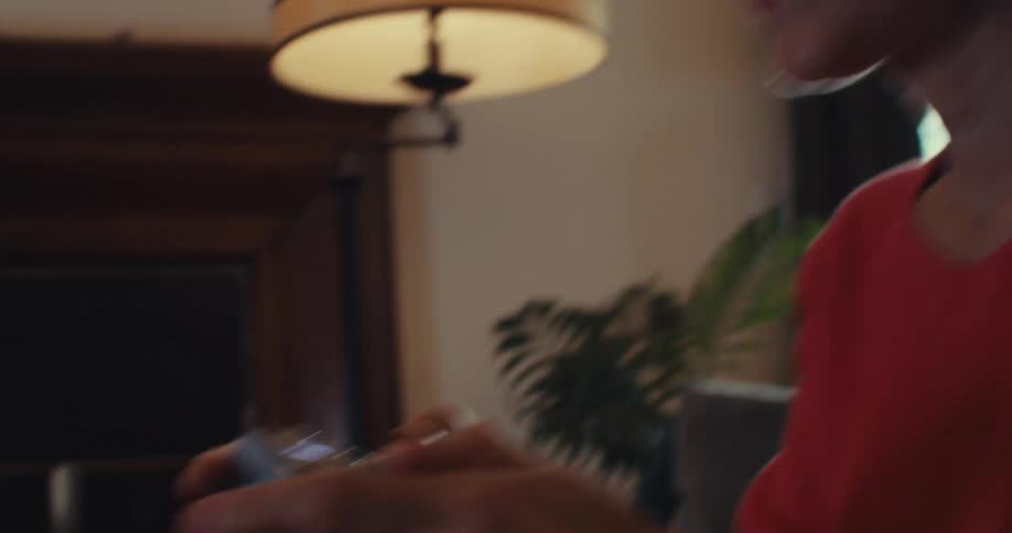 The woman is using a controller to play video games