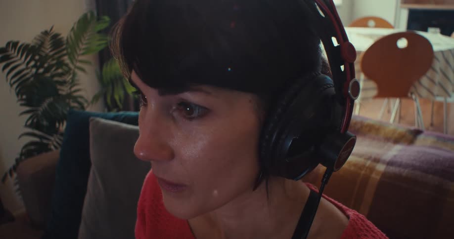 The woman presses the buttons on the controller