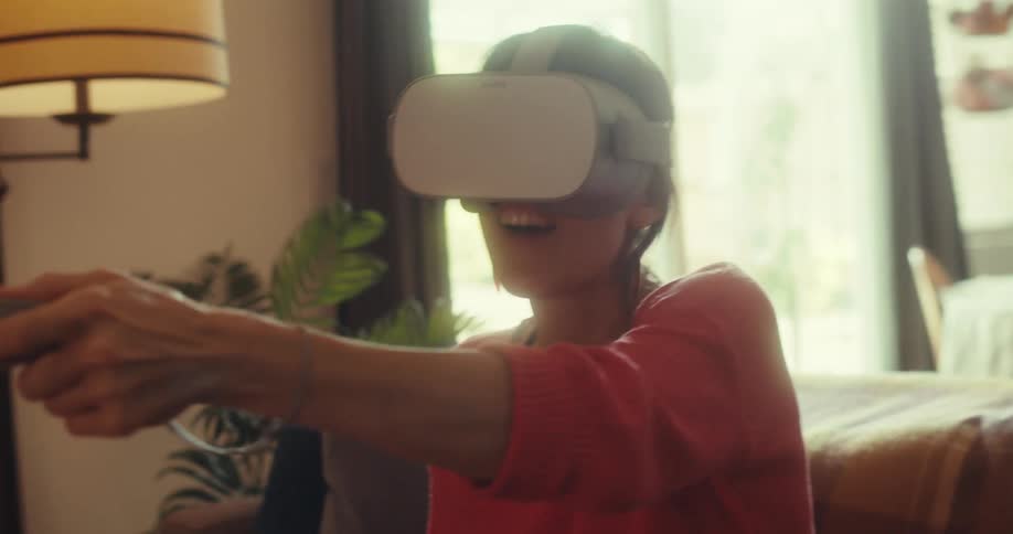 Woman sitting interacting with virtual reality glasses