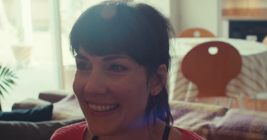 A woman happily holds a vr headset