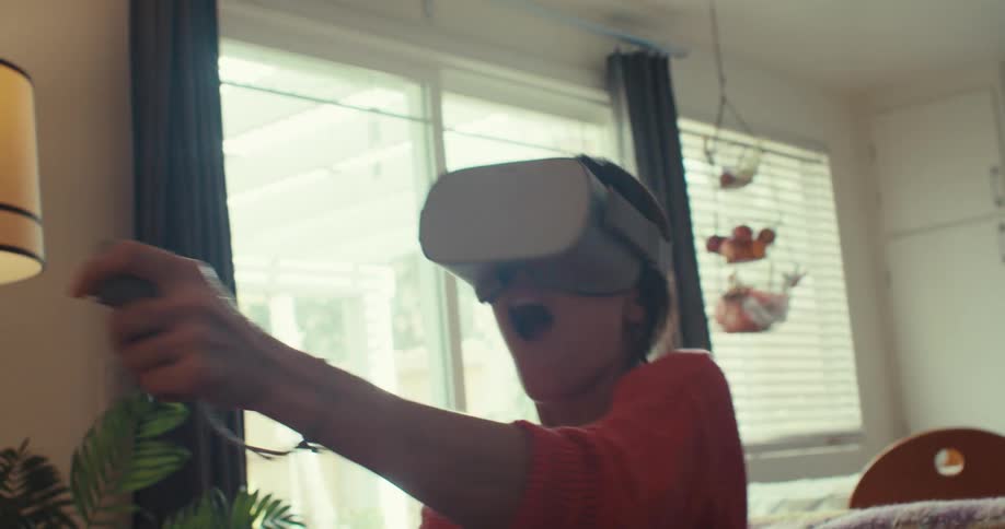 The woman slowly moves the controller around