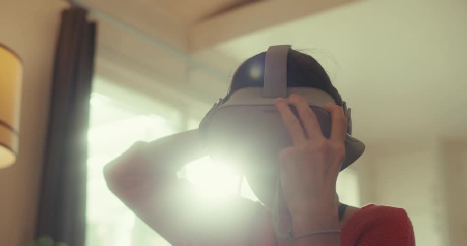 A woman puts on a vr headset